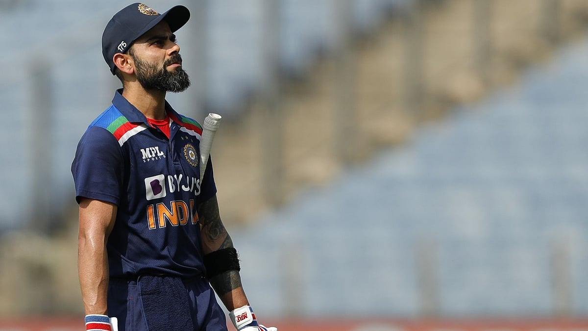 Virat Kohli walks back to the dressing room after getting out on 66.