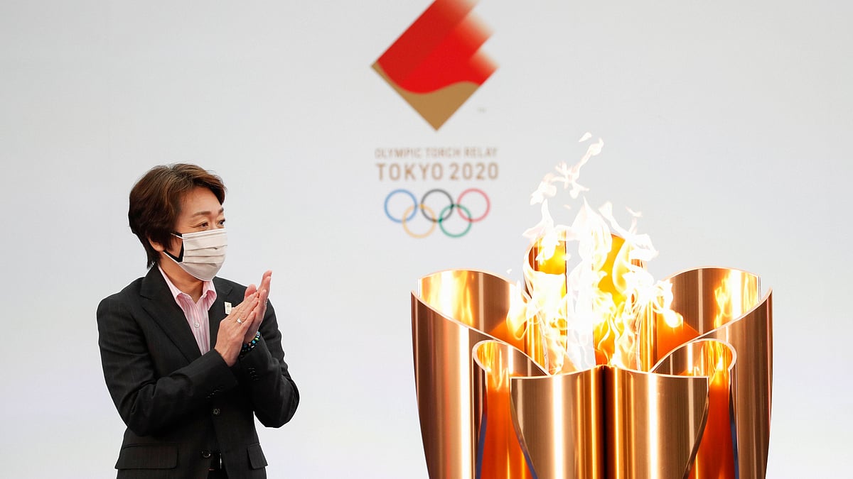 Tokyo 2020 Organizing Committee President Seiko Hashimoto applauds next to the celebration cauldron on the first day of the Tokyo 2020 Olympic torch relay in Naraha, Fukushima prefecture, northeastern Japan, Thursday, March 25, 2021. 