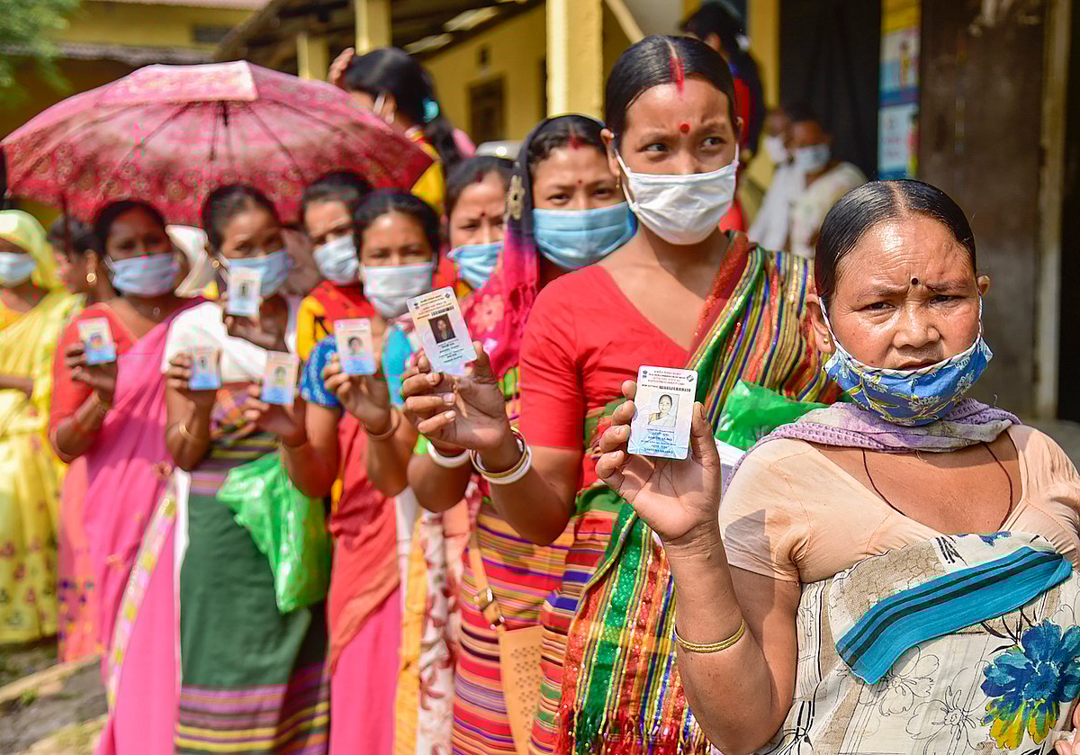 Kamrup: Hajong tribal women show their voter identity cards as they wait in queue to cast their votes at a polling station for Assam Assembly polls, at Boko in Kamrup district, Tuesday.&nbsp;