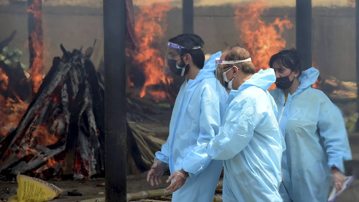 Mass cremation of people who died of COVID-19 disease, as coronavirus cases surge, at Ghazipur Crematorium in Delhi, on Friday, 30 April.