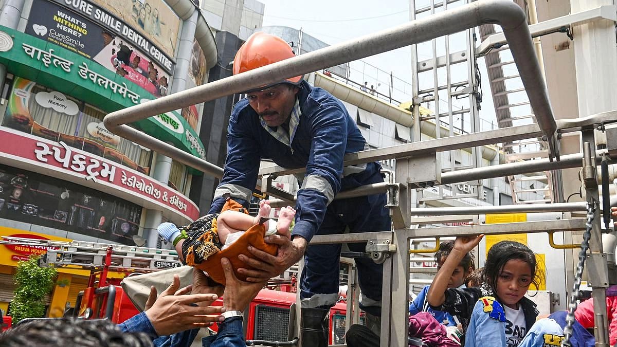 <div class="paragraphs"><p>Fire fighters rescue patients after a fire broke out at a children’s hospital in Ahmedabad on Saturday, 25 June, 2022.</p></div>