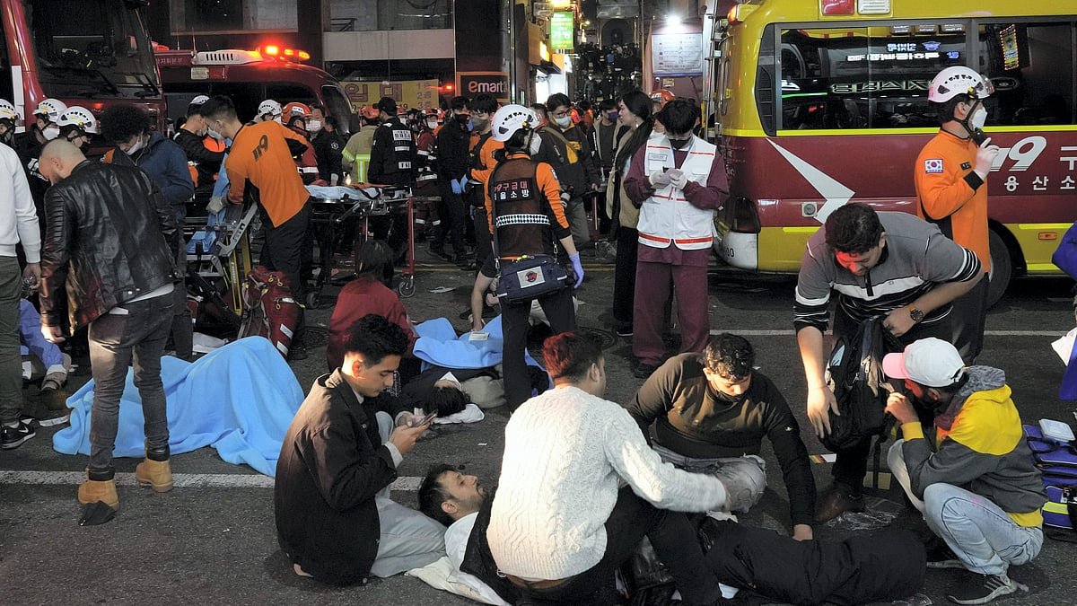 <div class="paragraphs"><p>Rescue workers and firefighters try to help survivors after a stampede killed over 154 in South Korea's Seoul on Saturday, 29 October. </p></div>