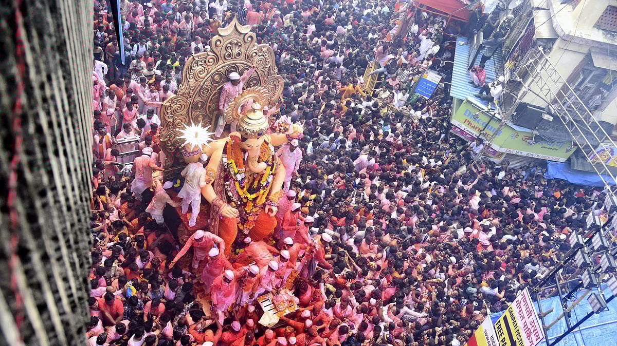 <div class="paragraphs"><p>Devotees celebrate during the procession of Lalbaugcha Raja idol of Lord Ganesha before its immersion (visarjan) as part of the Ganesh Chaturthi festival in Mumbai on Thursday, 28 September.</p></div>