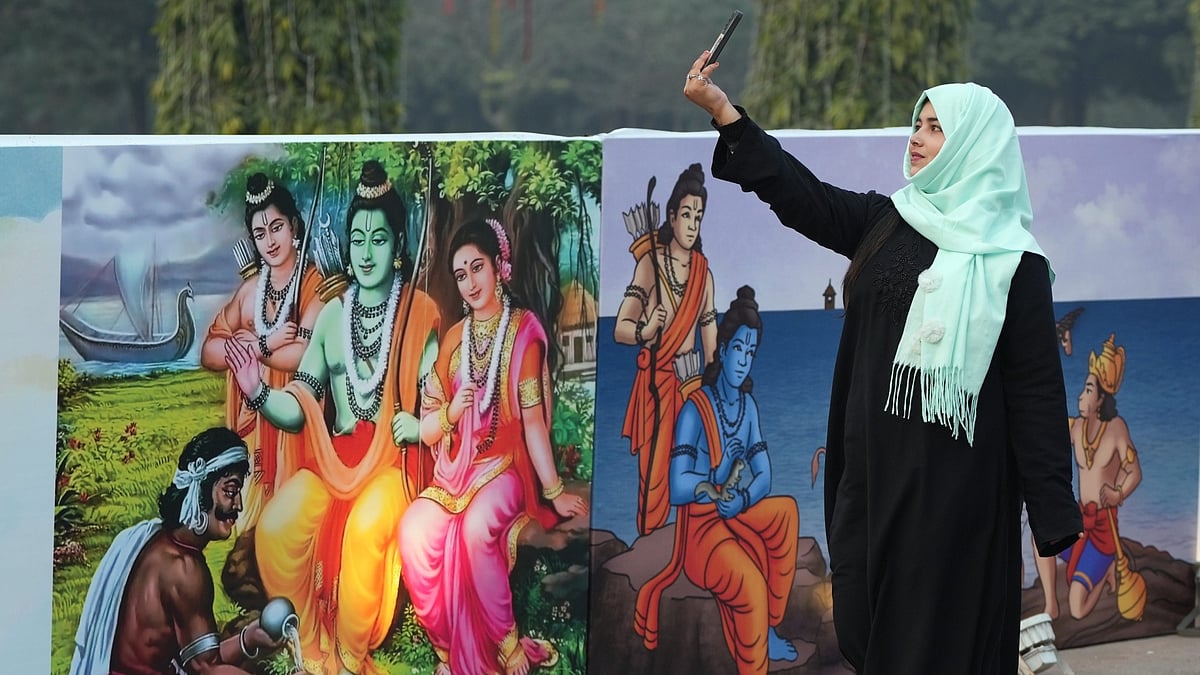 <div class="paragraphs"><p>A young woman takes a selfie near graffiti of Lord Ram at Purana Qila in New Delhi on Thursday, 18 January. </p></div>