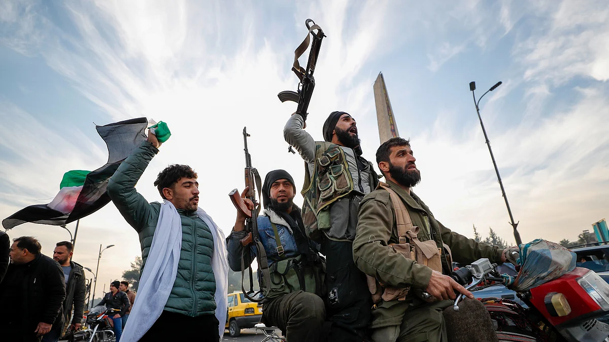 <div class="paragraphs"><p>Syrian opposition fighters celebrate in Damascus on Sunday, 8 December, after the fall of the Bashar Assad-led government.&nbsp;</p></div>
