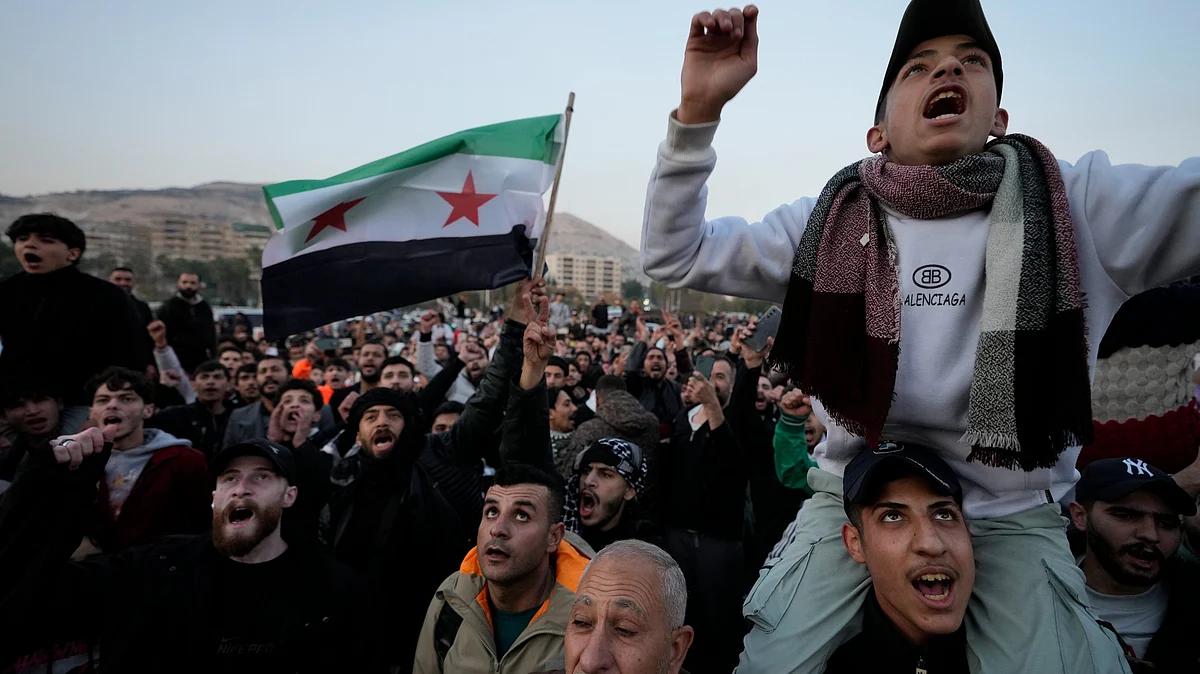 <div class="paragraphs"><p>Syrian citizens wave the revolutionary flag and shout slogans as they celebrate during the second day of the takeover by insurgents in Damascus on Monday, 9 December.&nbsp;</p></div>