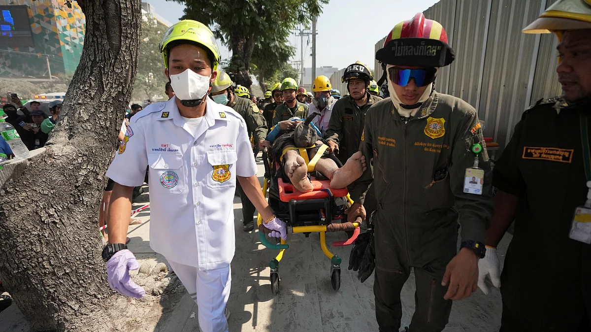 <div class="paragraphs"><p>Rescuers carry an injured from the site of a high-rise building under construction that collapsed after a 7.7 magnitude earthquake in Bangkok, Thailand</p></div>