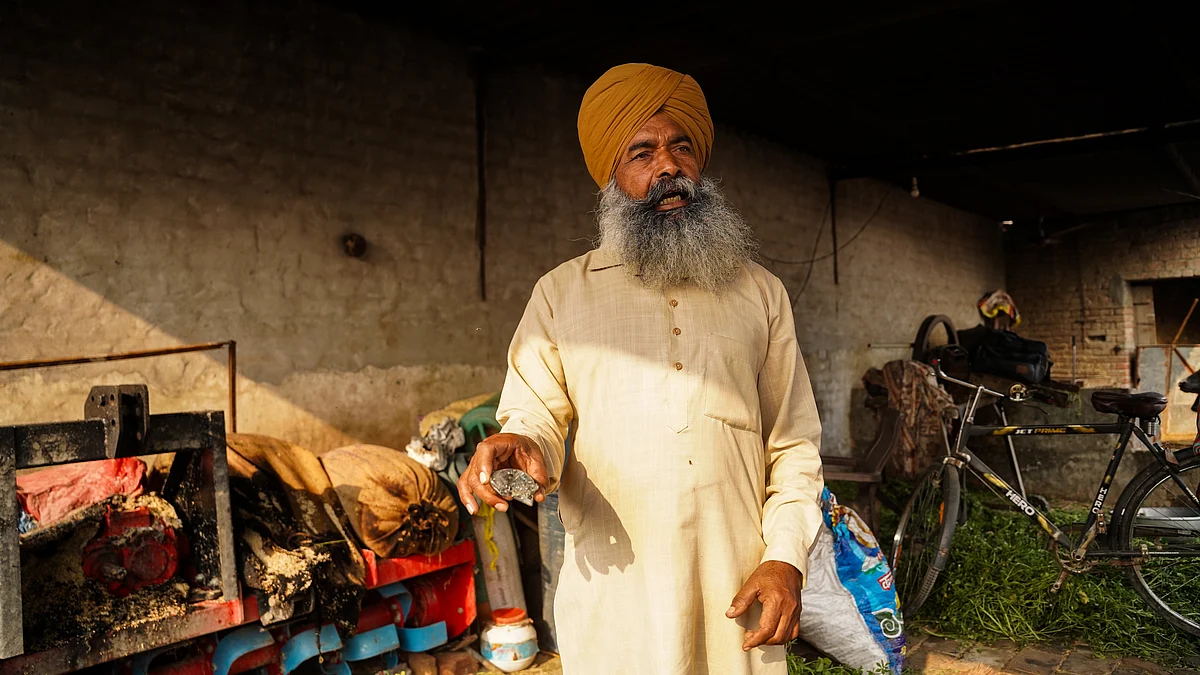 <div class="paragraphs"><p>A neighbor of the family injured in last night’s drone strike stands inside their home, inspecting unidentified debris scattered across the floor, on May 10 in Khai Phemeki, Ferozepur Tehsil, Punjab.</p></div>
