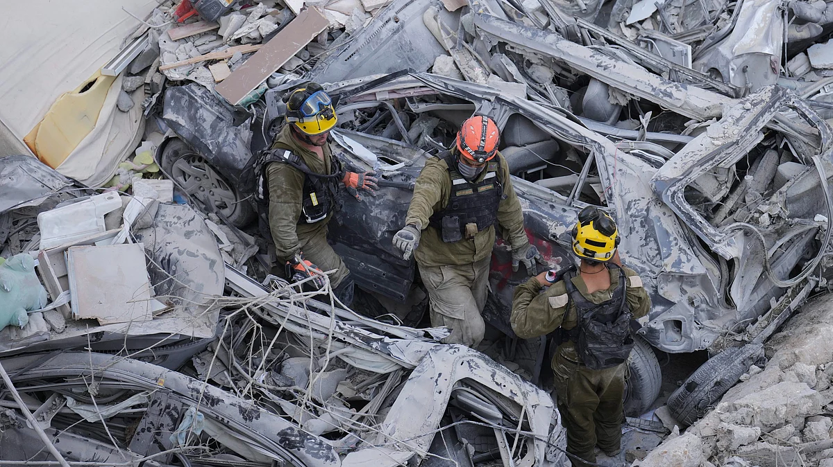 <div class="paragraphs"><p>Israeli soldiers dig through rubble to search for survivors in a residential area in Tel Aviv hit by a missile fired from Iran on Sunday, 15 June.&nbsp;</p></div>