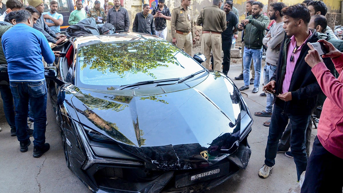 <div class="paragraphs"><p>People gather around a Lamborghini car which collided with a rickshaw, injuring three people, in Kanpur, Sunday, 8 February, 2026.</p></div>