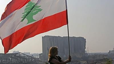 <div class="paragraphs"><p>A woman holds a Lebanese national flag near the Beirut port in Beirut, Lebanon, on Sept. 4, 2020. (Image for representational purpose only)</p></div>