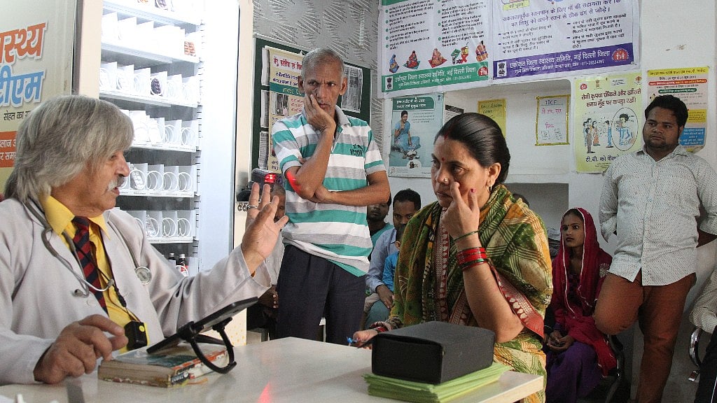 Dr R Pal examining patients at Todapur mohalla clinic in west Delhi.