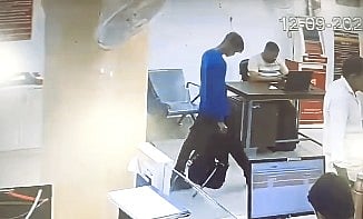 man stealing money from bank