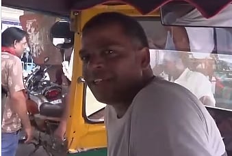Indian autorickshaw driver speaking fluently in French 