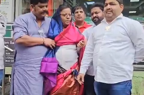 BJP workers dress Congress leader in saree