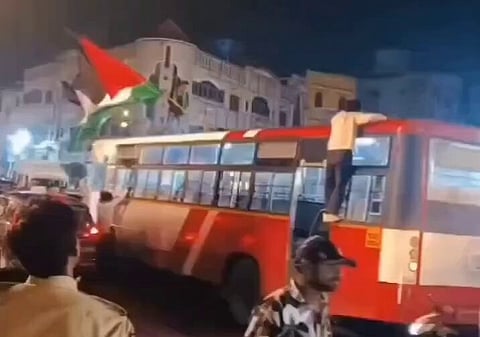 Semi-naked men waving Palestinian flag 