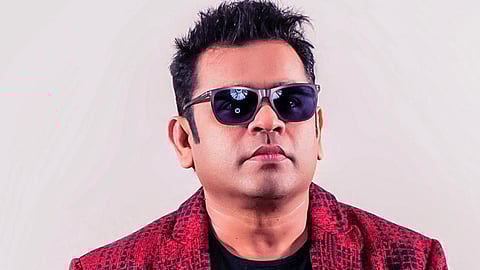 Music composer AR Rahman in a black t-shirt, red and black blazer and sunglasses