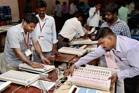 Poll officials arranging ballot boxes for Assembly polls