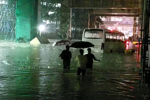 People wading through rain in Bengaluru