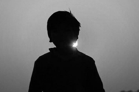 A boy in silhouette