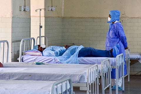 A medic looks on at a patient who has shown positive symptoms for coronavirus at an isolation ward in Hyderabad