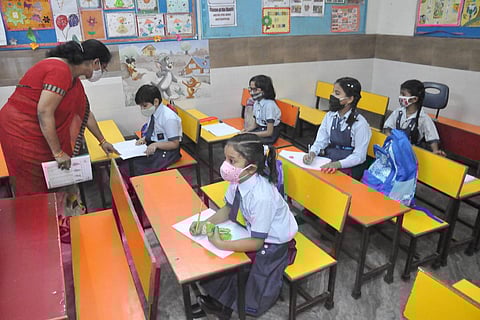 Primary students attend their class at a school which reopened after COVID restrictions were eased