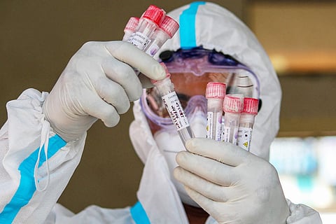 A doctor in PPE kit checking blood samples