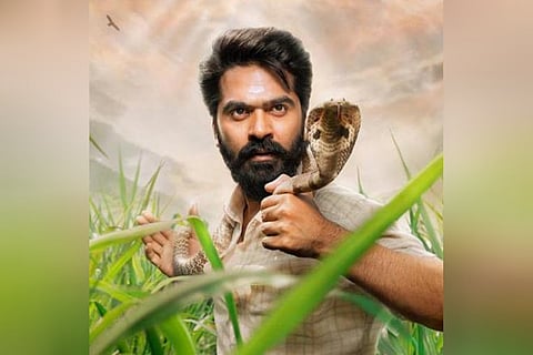 Simbu is seen with a king cobra wrapped around his neck.
