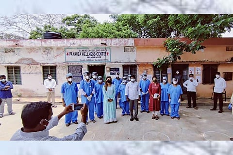Health care workers along with officials