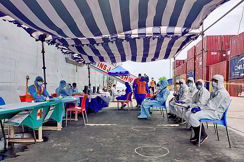 PPE kit clad people in the ship 