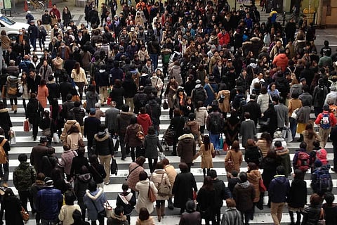 Crowd of people crossing the road