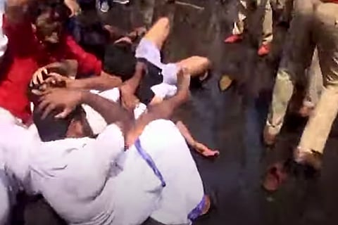Kerala KSU Workers keeping hands on head  during a clash with the police outside the Secretariat 