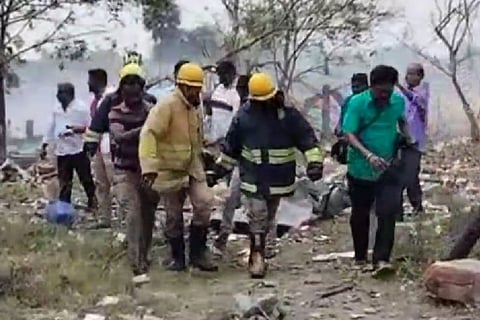 Fire service personnel carrying the body of a person