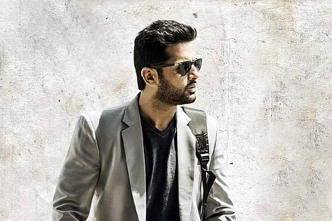 Nithiin is donning grey blazer and black shades in the image.