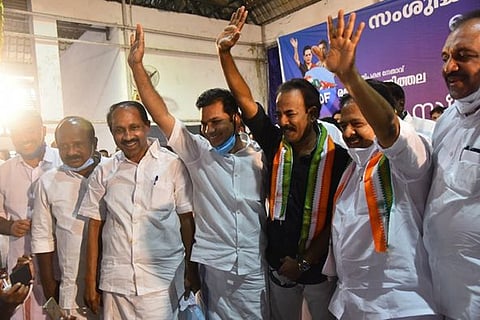 Malayalam Film Maker Major Ravi waving hands with Ramesh Chennithala and other Congress leaders on a Congress poll rally 
