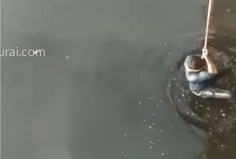 Man being rescued from Cooum river