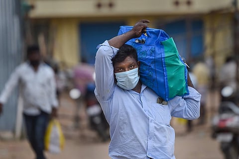 Man carrying liquor bottles in a bag