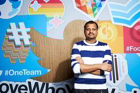 Twitter India Head Manish Maheshwari stands against an illustrated wall