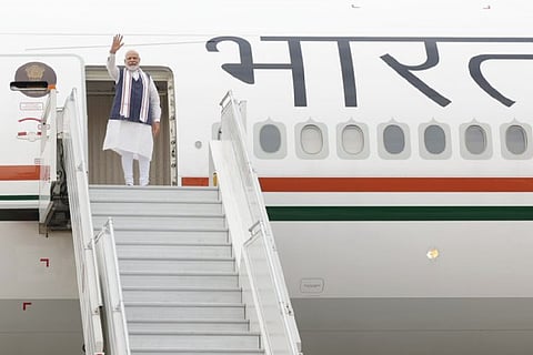 PM Modi waving after boarding plane for US visit