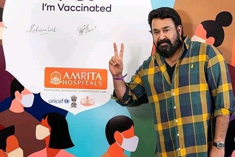 Mohanlal posing with a victory sign after getting vaccinated