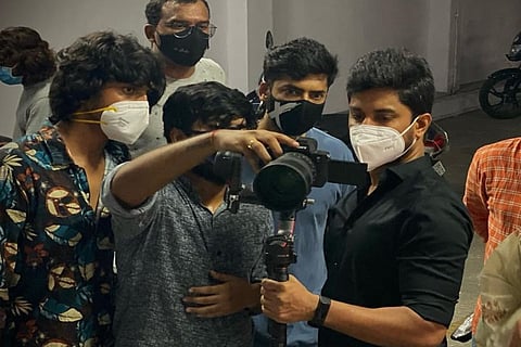 Nani is seen looking at a camera along with other people who are likely to be crew members.
