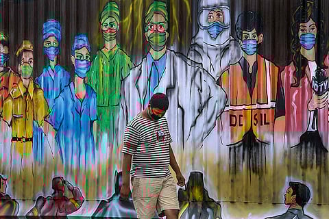 Man walking past mural