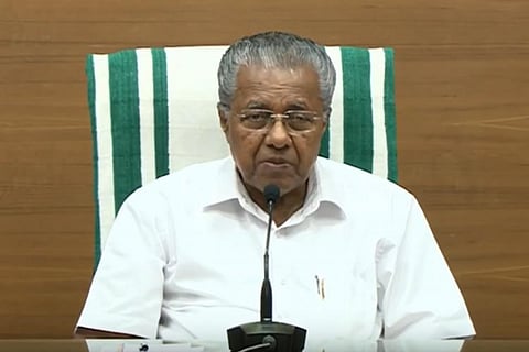 Kerala Chief Minister Pinarayi Vijayan facing a mike 