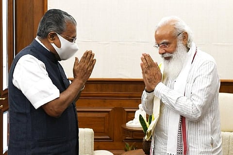 Kerala CM Pinarayi Vijayan and Prime Minister Narendra Modi greeting each other with folded hands