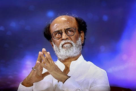 Actor Rajinikanth is seen donning a white shirt, spectacles and beard in a press meet
