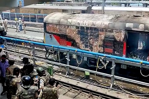 A train bogey set ablaze by protesters at Secunderabad railway station. 