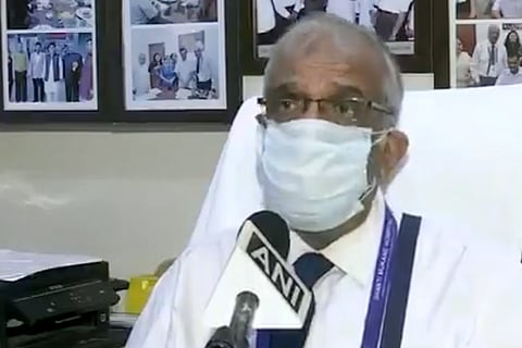 Sunil Saggar in a mask talking to ANI