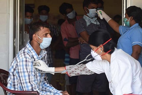 A doctor using a stethoscope to check a patient