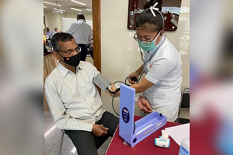 A woman health professional checking a patient's vitals