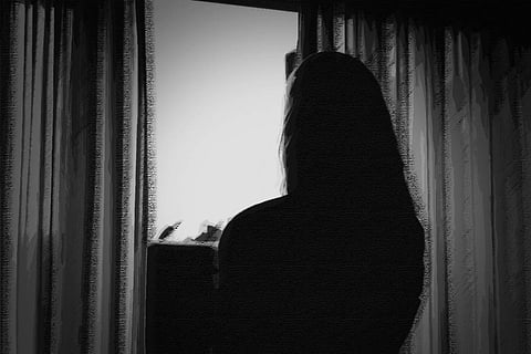 A file photo of a woman in silhouette